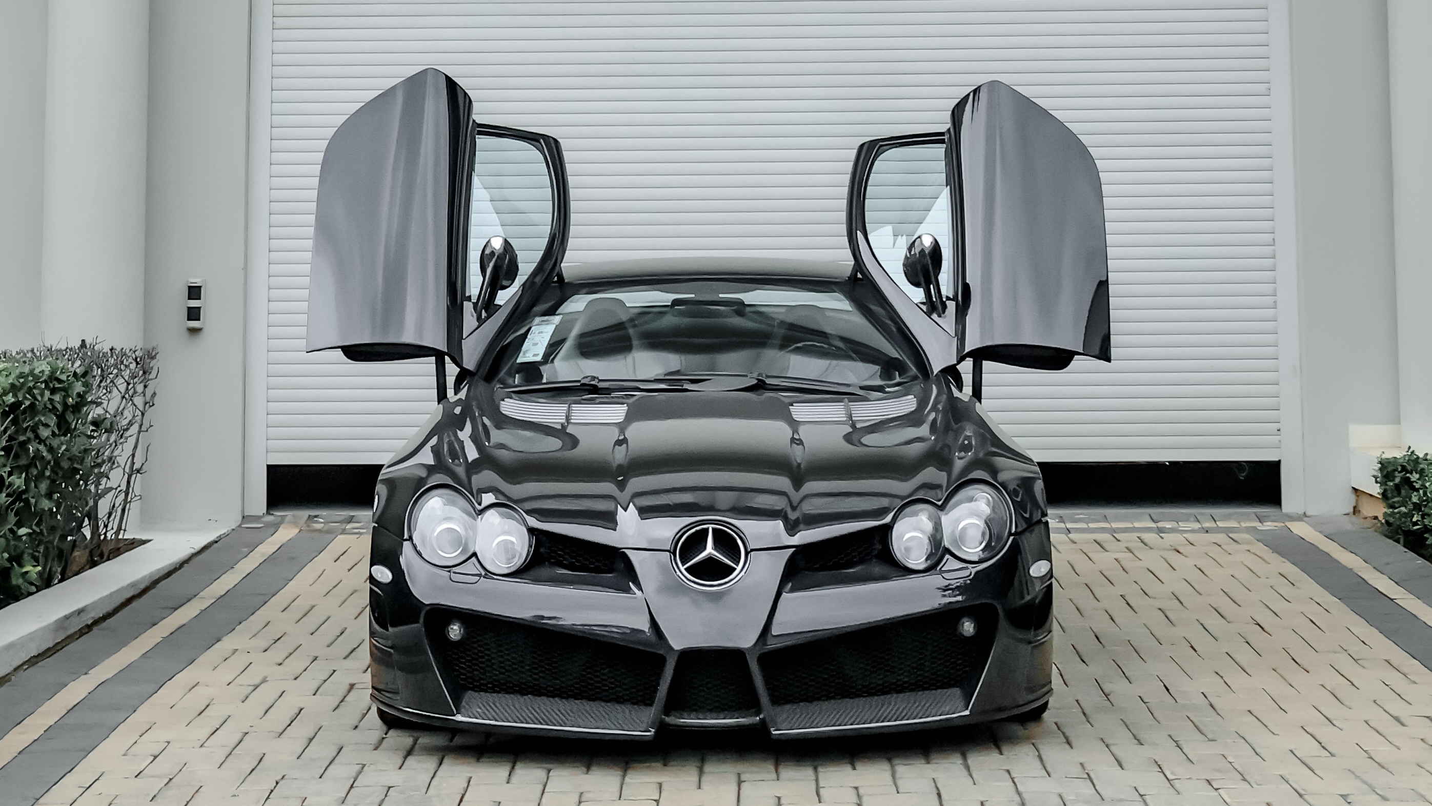 Black Mercedes-Benz SLR with its doors raised